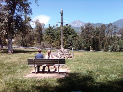 A replica of the San Bernardino Mountain Initial Point and San Bernardino Peak in the background