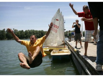 Riverside Mayor William “Rusty” Bailey takes a victory bath in Lake Evans with a little help from interim fire chief Mike Esparza, right, during the annual Regatta & Hot Dog BBQ at Fairmount Park on Saturday, June 21, 2014. Both men won their respective sailboat races. DAVID BAUMAN, DAVID BAUMAN STAFF PHOTOGRAPHER - The Press Enterprise